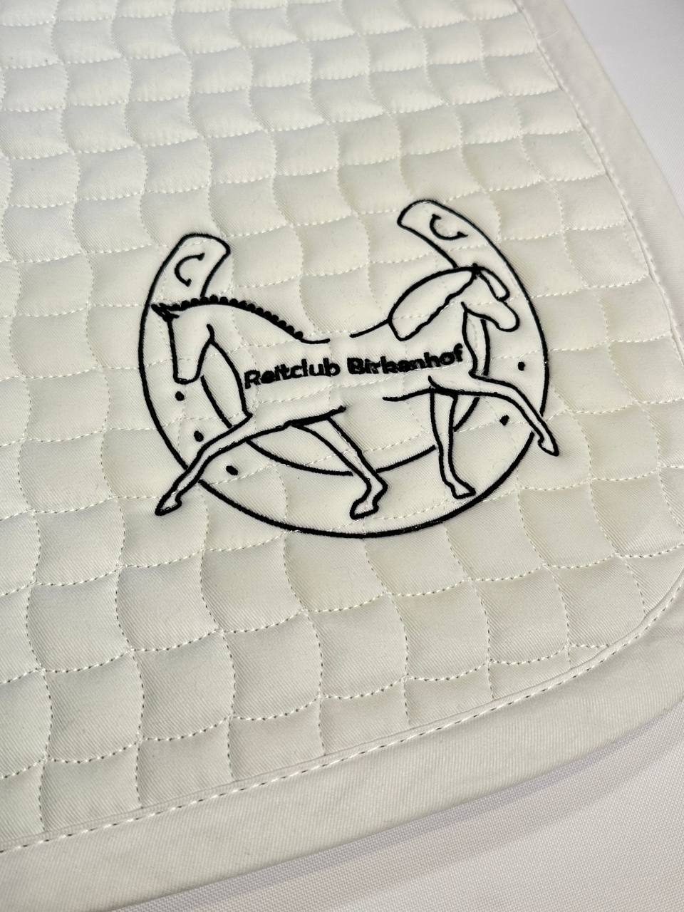 Reitclub Birkenhof Wappen auf weißer Schabracke gestickt, Reitsport-Stickerei Wien